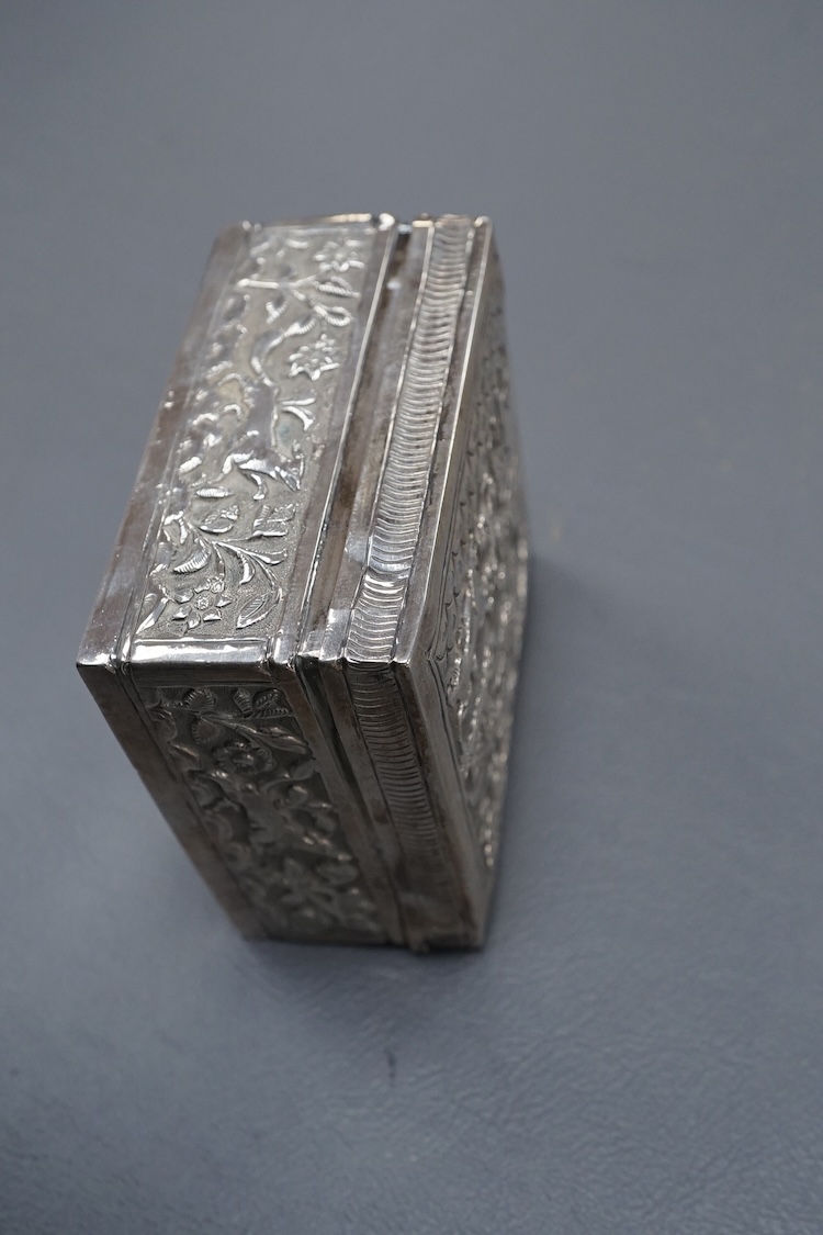 An Indian small square white metal cigarette box, embossed with animals and figures, width 78mm, 4.4oz.